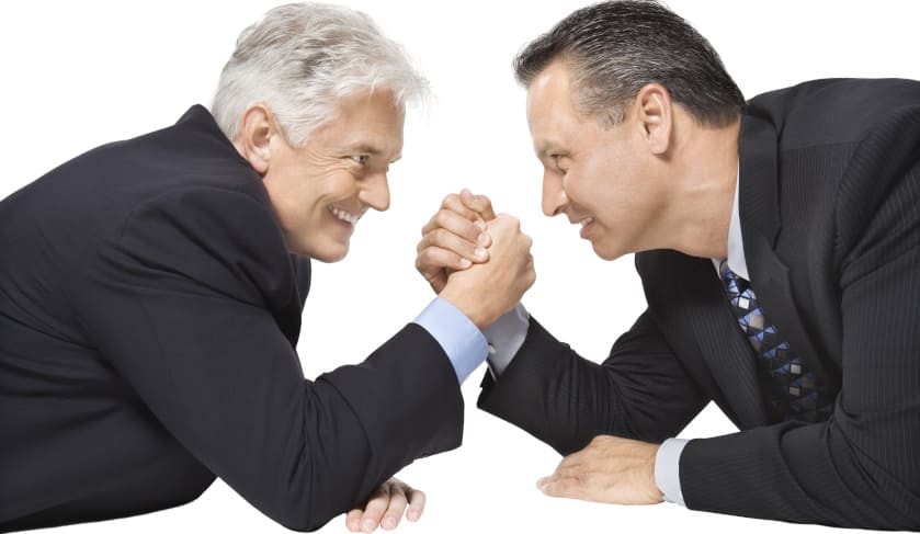 men in suits arm wrestling