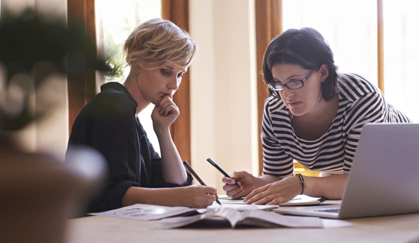 women with papers and laptop